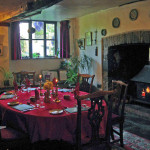 Breakfast in the medieval dining room next to a crackling log fire