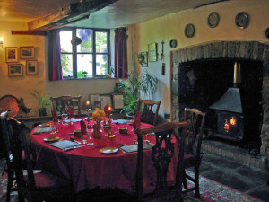 Breakfast in the medieval dining room next to a crackling log fire