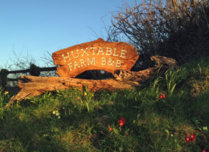 Huxtable Farm B&B sign at entrance to farm B&B lane opposite West Buckland School