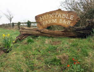 Huxtable Farm B&B sign at entrance to farm opposite West Buckland public School