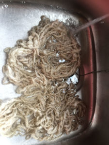 Wash the raw wool skein