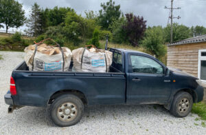 Truck with two dumpy bags of logs